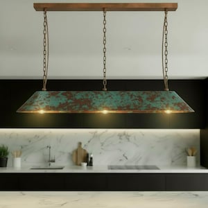 May include: A rectangular, rustic-style pendant light fixture with a distressed teal and brown finish. The light hangs from a wooden beam and is suspended by chains. The fixture has three lights and is suitable for a kitchen or dining area.