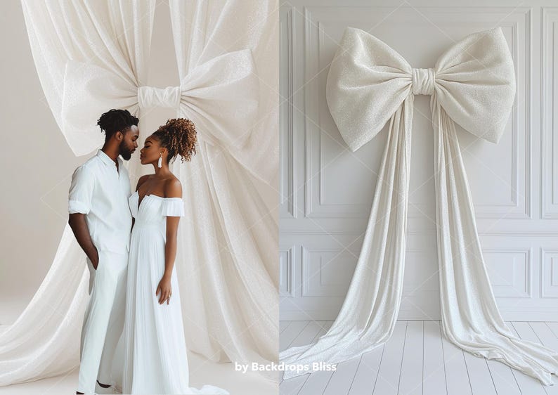 May include: A couple in white clothing stand in front of a white fabric backdrop with a large bow. The woman is wearing a white off-the-shoulder dress and the man is wearing a white button-down shirt and trousers.