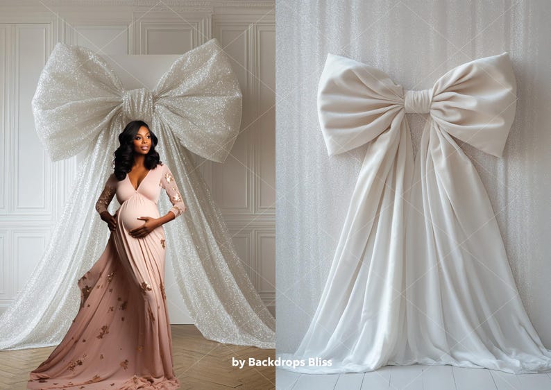 May include: A white backdrop with a large white bow made of fabric. A pregnant person is standing in front of the backdrop wearing a long, pink dress.