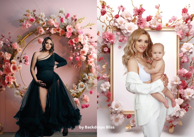 May include: Two women, one pregnant, pose in front of floral backdrops. The pregnant woman wears a black dress with a tulle skirt. The other woman wears a white blazer and holds a baby. Both backdrops feature pink and white flowers.