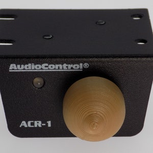 May include: A black AudioControl ACR-1 volume knob with a wood-tone knob. The knob has a small LED light on the front.