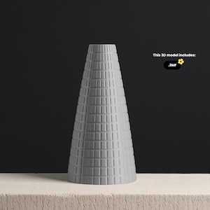 May include: A gray ceramic vase with a geometric pattern. The vase is cone-shaped and has a wide opening at the top.