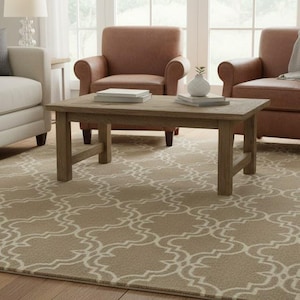 May include: A living room scene featuring a beige patterned area rug. The rug is under a wooden coffee table, a white sofa, and two brown armchairs. A woven basket and decorative vase are also visible.