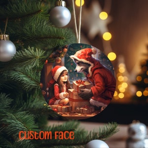 May include: Round Christmas ornament featuring a raccoon dressed as Santa Claus giving gifts to a girl. Both are wearing red Santa suits. The ornament has the text "Custom face" in orange. The ornament hangs from a Christmas tree.