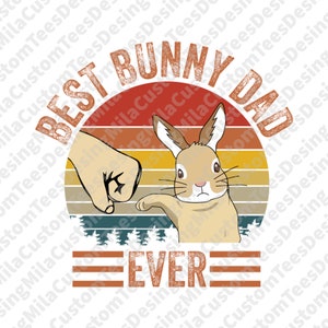 May include: A retro-style graphic with a sunset background and the text "Best Bunny Dad Ever". A cartoon bunny rabbit is shown with a fist bump from a hand.