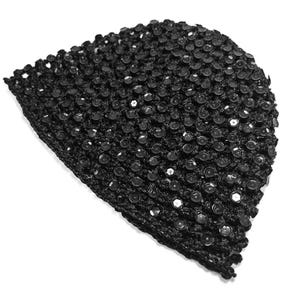 May include: A black, crocheted hat covered in small, shiny sequins. The hat is a dark color and has a textured appearance. The sequins are evenly spaced across the surface, creating a sparkling effect. The hat is likely for fashion or special occasions.