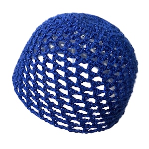 May include: A blue crocheted beanie hat. The hat is made of a loosely woven, open-stitch pattern, allowing glimpses of the background. The yarn has a slight sheen, adding a subtle sparkle. The hat is a solid, vibrant blue color.