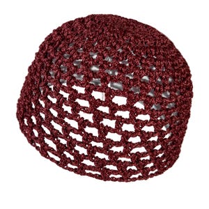 May include: A burgundy crocheted hat with a wide brim and a delicate open weave pattern.