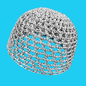 May include: A silver crocheted beanie hat. The hat is made of a loosely woven, open-weave material, creating a net-like appearance. The hat is set against a bright blue background.