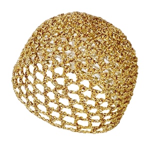 May include: A gold-colored, crocheted, round, decorative ornament with a sparkly finish.