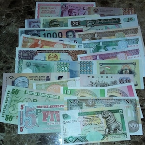 May include: A collection of colorful paper money from around the world. The bills feature various denominations, including 1, 5, 10, 20, 50, 100, 500, and 1000. Some of the bills are in English, while others are in different languages. The bills are in various states of wear and tear, but they are all in good condition.