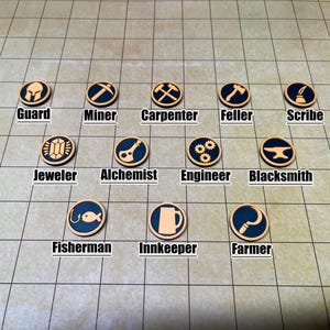 May include: A collection of twelve circular tokens with various profession symbols, including a guard's helmet, pickaxe, and a carpenter's crossed tools. Each token has a dark blue center and a tan border, with the profession's name below.