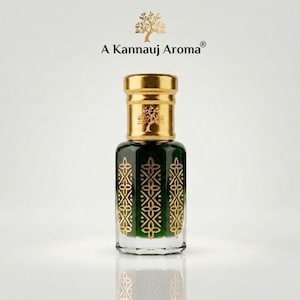 May include: A glass perfume bottle with a dark green body and gold geometric patterns. The bottle features a gold cap with a tree emblem and the text A Kannauj Aroma. The design includes a matching tree logo above the brand name text.