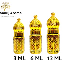 May include: Three glass perfume bottles with gold-colored ornate caps and decorative lattice patterns on the bodies. The bottles are labeled 3 ML, 6 ML, and 12 ML. The text A Kannauj Aroma and the slogan ENHANCE YOUR PERSONALITY appear at the top.