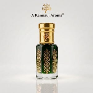 May include: A glass perfume bottle with a dark green liquid, featuring a gold cap and gold geometric floral patterns on the sides. The text A Kannauj Aroma is printed above the bottle with a small tree icon centered above the brand name.