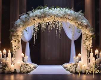 May include: A white floral archway with white sheer curtains and candles on either side. The archway is decorated with white flowers and greenery. The candles are in glass holders and are lit. The archway is set up for a wedding ceremony.
