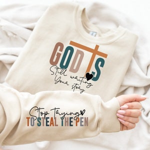 God is Still Writing Your Story Sweatshirt and Hoodie , Bible Verse Sweatshirt for Women, Jesus Lover with Sleeve Design, Religious Sweats