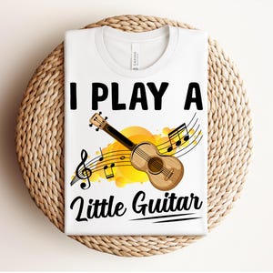 Ukulele Shirt, Little Guitar Shirt, Funny Ukulele Musician, Pun Gift for Uke Lovers, Sunny Melodies, Playful Ukulele with Music Notes Tee