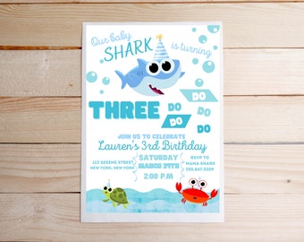May include: A blue and white shark with a party hat is the centerpiece of this birthday invitation. The invitation is for a child turning three and includes the text "Our baby shark is turning three" and "Join us to celebrate Lauren's 3rd birthday".