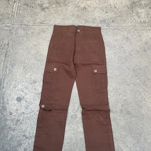 May include: A pair of brown cargo pants with multiple pockets and button closures.