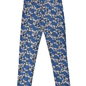 May include: Blue and white floral print pants. The pants have a slim fit and a straight leg.