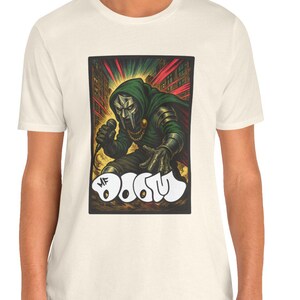 May include: A white t-shirt with a graphic print of a green and black superhero character holding a microphone. The text "Mr. Doom" is printed below the character.