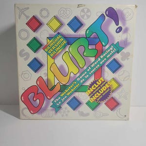 May include: A box for the board game "BlurT!" The Webster's Game of Word Racing! The box is white with a colourful design and the game title is in large, colourful letters. The box also includes the text "Bilingual Version" and "The Webster's Game of Word Racing! Le jeu Webster de la course aux mots!"