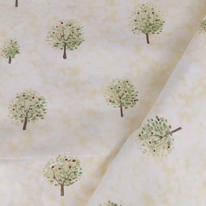 May include: A piece of fabric featuring a repeating pattern of small apple trees with green leaves and red fruit on a light cream-colored background with a mottled texture. The textile is folded, showing the print across the surface.