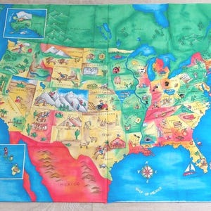 May include: A colorful, illustrated map of the United States, featuring each state with unique drawings and labels. The map includes the Pacific and Atlantic Oceans, the Gulf of Mexico, and Mexico. The map is on a light-colored fabric.