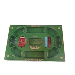 May include: A green Tripoley game board featuring a central pot area, designated sections for Jack, Queen, King, Ace, and Kitty, and the text 8-9-10 ALL ONE SUIT. The board includes a red Cadaco game card and two small cylindrical game pieces in blue and red.