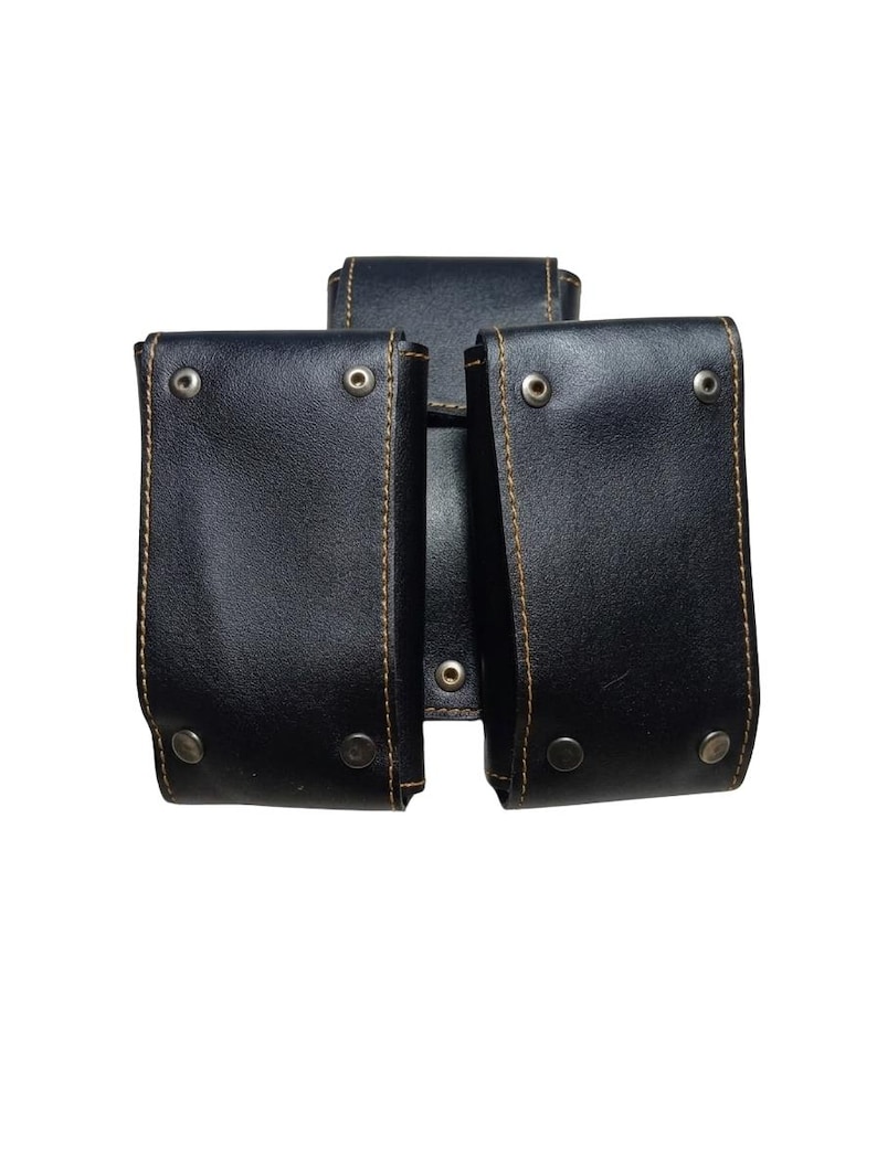 May include: Black leather pouch with three compartments. Each compartment has a flap secured with a metal snap. The edges are stitched with brown thread. The background is white.