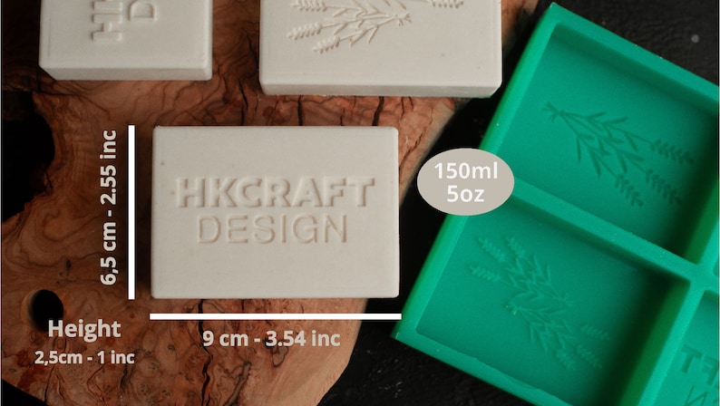 May include: A white rectangular soap bar with the text "HKCRAFT DESIGN" embossed on it. The soap bar is 6.5 inches tall and 3.54 inches wide. A green silicone mold with two rectangular cavities is shown in the background. The mold is labeled "150ml 5oz".