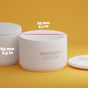May include: White cylindrical container with a lid, labeled "HKCRAFT DESIGN". The container is 3.7 inches tall and 2.5 inches wide.