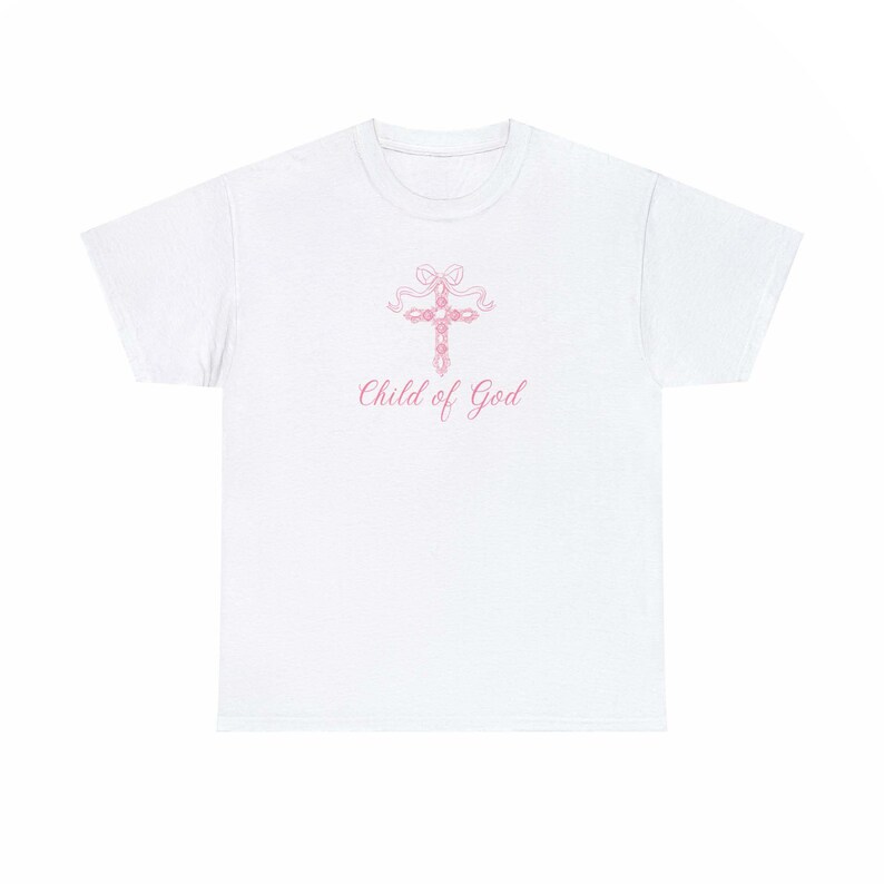 May include: White t-shirt with a pink cross and the text "Child of God" printed on the front.