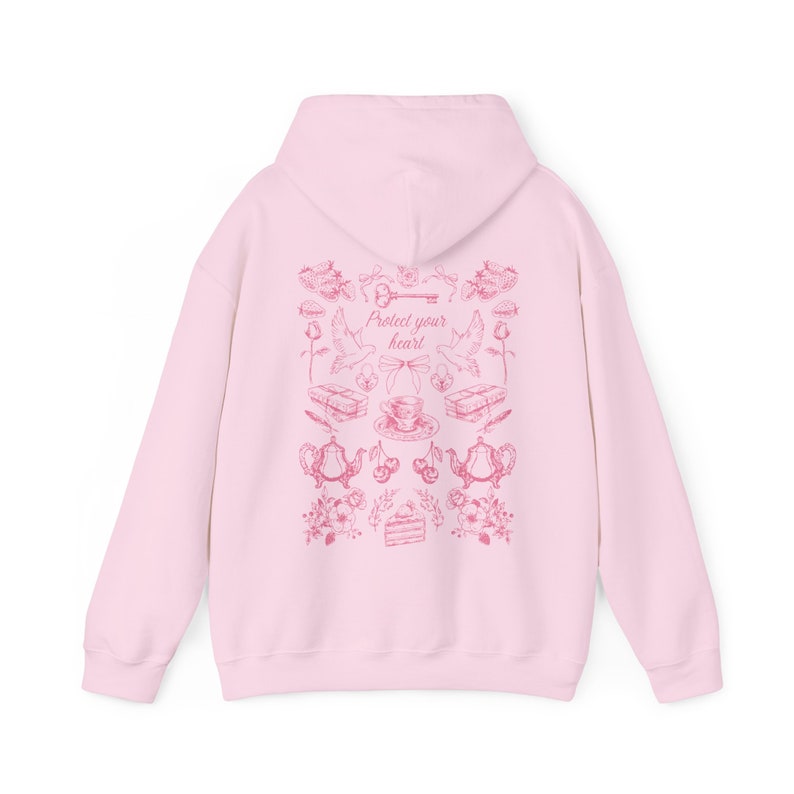 May include: Pink hoodie with a pink graphic print of a key, doves, teacups, cherries, and a cake. The graphic print says "Protect your heart".