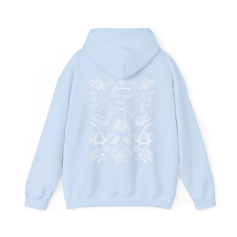 May include: Light blue hoodie with a white graphic print on the back. The graphic features a key, teacups, teapots, and flowers. The text "Protect your heart" is centered on the graphic.