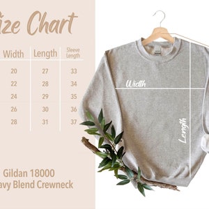 May include: Size chart for a Gildan 18000 Heavy Blend Crewneck sweatshirt. The chart shows the width, length, and sleeve length in inches for sizes S, M, L, XL, and 2XL.