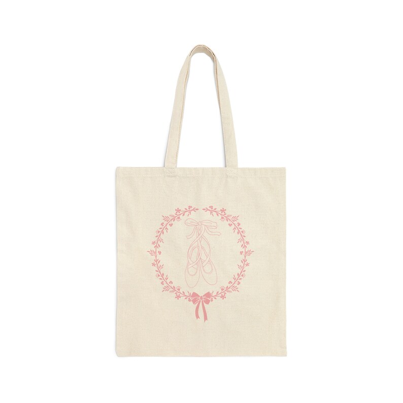 May include: A natural-coloured tote bag with a pink design of ballet shoes in a floral wreath.