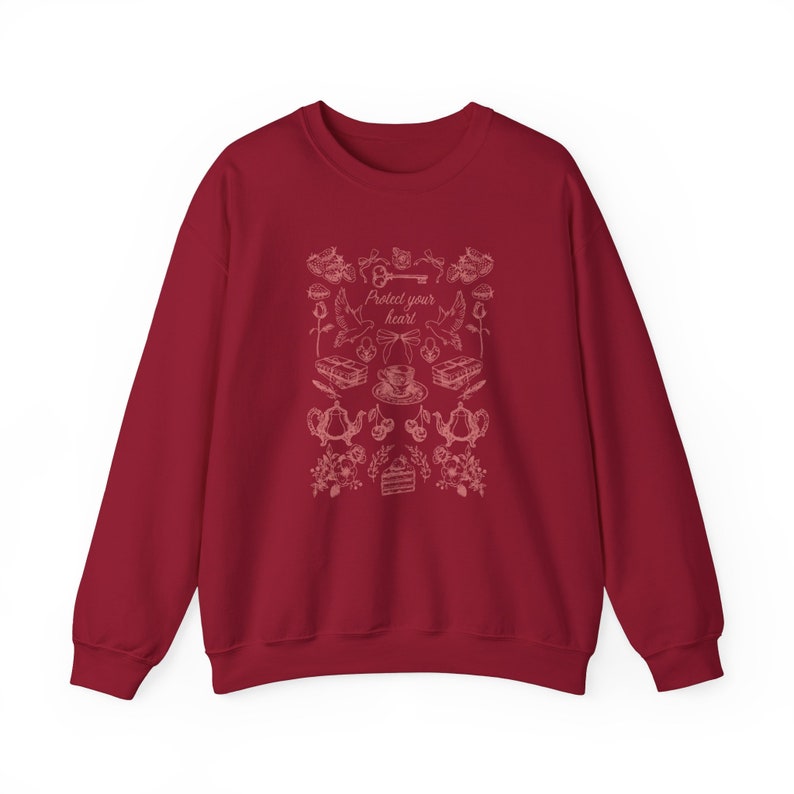 May include: Burgundy red sweatshirt with a white graphic design featuring a key, birds, teacups, and the text "Protect your heart".