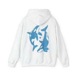 May include: White hoodie with a blue graphic of two orcas swimming in a circle with a small heart in the center.