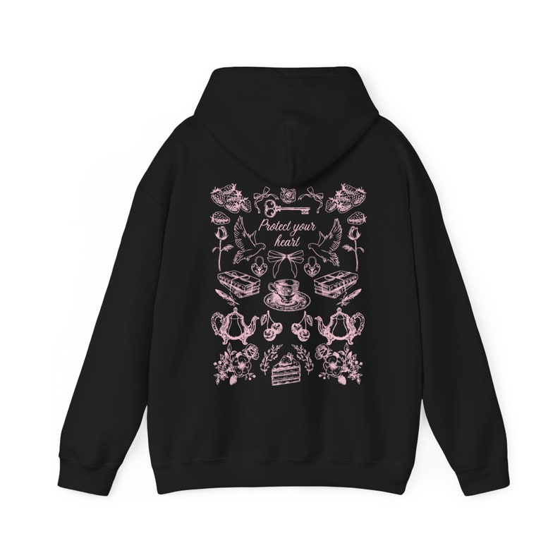 May include: Black hooded sweatshirt with a pink graphic print of a key, doves, teacups, cherries, and cake. The text "Protect your heart" is printed in pink on the sweatshirt.