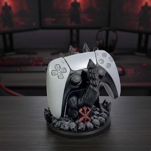 May include: A white and black games controller on a black stand with a skull and spike design. The stand also features a red symbol. The controller has a modern design with a sleek, curved shape.