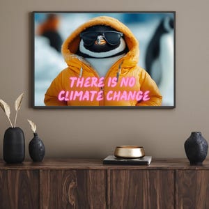 May include: A penguin wearing sunglasses and a yellow hooded jacket with the text "THERE IS NO CLIMATE CHANGE" in pink.