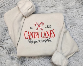 Embroidered Christmas Candy Canes Sweatshirt - Kringle Candy Company Embroidered Unisex Crewneck Sweatshirt or Hooded Sweatshirt.