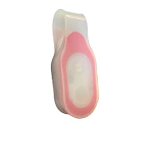 May include: A small, clip-on LED safety light. The light is encased in a clear, flexible material with a pink accent. The light has a white LED and a button. This safety light is designed to be attached to clothing or gear.