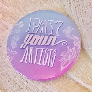 May include: A purple and blue gradient button with the text "PAY your ARTISTS" in white lettering. The button has a floral design around the edges.
