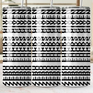 May include: Three stainless steel tumblers with a black and white geometric pattern. The design features repeating shapes including triangles, rectangles, and zigzags. Each tumbler has a silver lid and a straw.