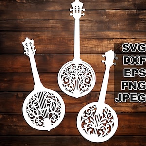 Può includere: Tre sagome bianche ritagliate di banjo con intricati disegni floreali. I banjo sono disposti in fila su uno sfondo a grana di legno.