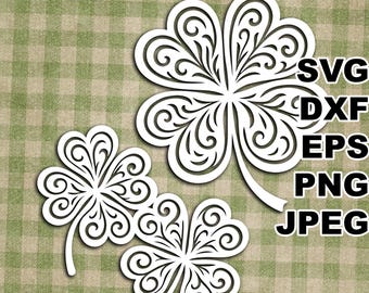 May include: Three white shamrock cutouts with detailed swirl patterns. The image features the text "SVG, DXF, EPS, PNG, JPEG" in black. The background is a green and beige plaid pattern, reminiscent of a tablecloth.