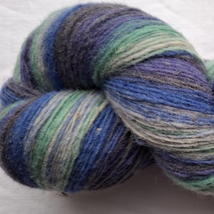 Wool yarn for knitting. High quality multicolor blue, green striped 100 % wool yarn . Natural lanolin wool yarn.